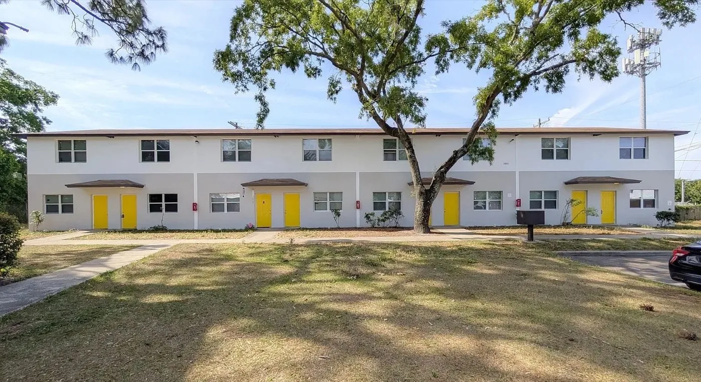 Row of white townhomes with yellow doors at Yellow Pine